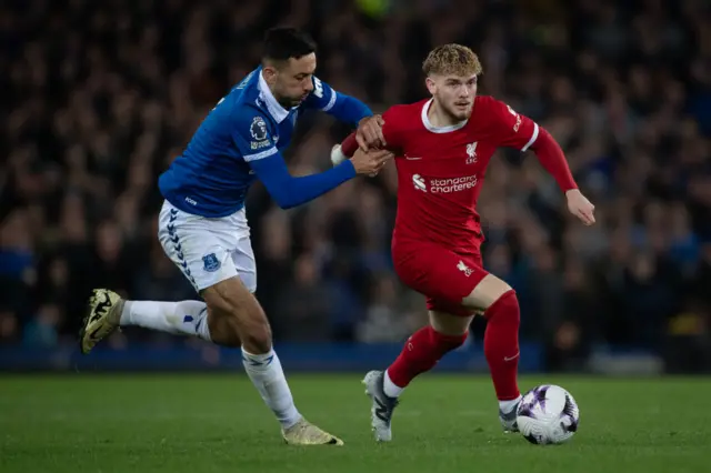 Harvey Elliott of Liverpool is challenged by Dwight McNeil of Everton, 24 April 2024