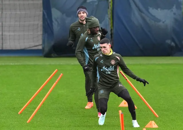 Man City players Foden, Doku and Kovacic do a drill in training