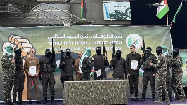 Members of Hamas' Al-Qassam Brigades release 3 Israeli male hostages prisoners Eli Sharabi, Or Levy and Ohad Ben Ami as they gather in the square as part of a hostage swap deal between Hamas and Israel, in Deir al Balah, Gaza, on February 8, 2025