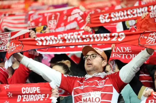 Brest supporters hold team scarves during their match with PSG