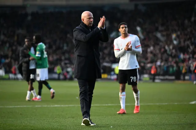 Slot applauds the Liverpool fans after their loss at Plymouth