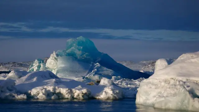 An iceberg floats off the coast of Greenland