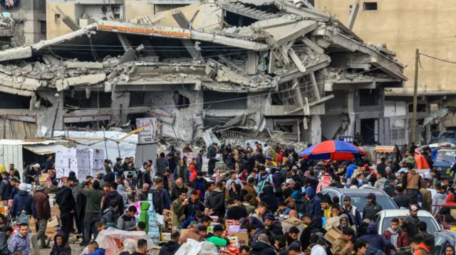 alestinian residents, shopping at the market, try to meet their basic needs among the collapsed buildings as they continue to live in Khan Yunis, Gaza, which was heavily damaged by Israeli airstrikes before their withdrawal, on February 12, 2025. (