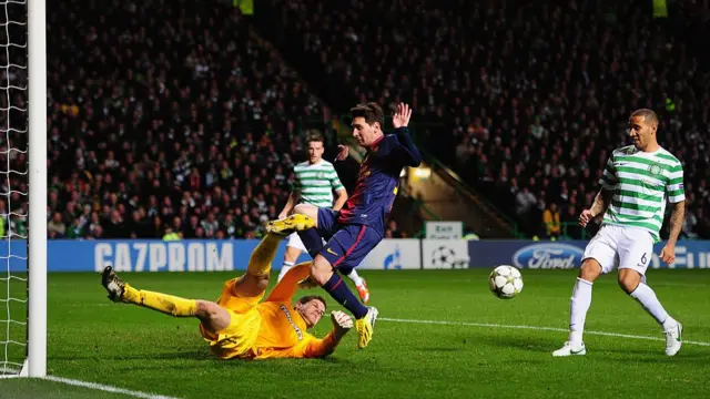 Celtic goalkeeper Fraser Forster challenges Barcelona's Lionel Messi