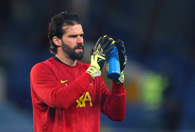 Alisson claps the away fans