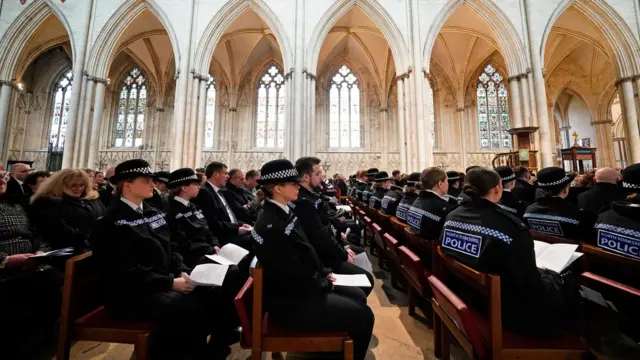 Police officers sit on pews in York Minster