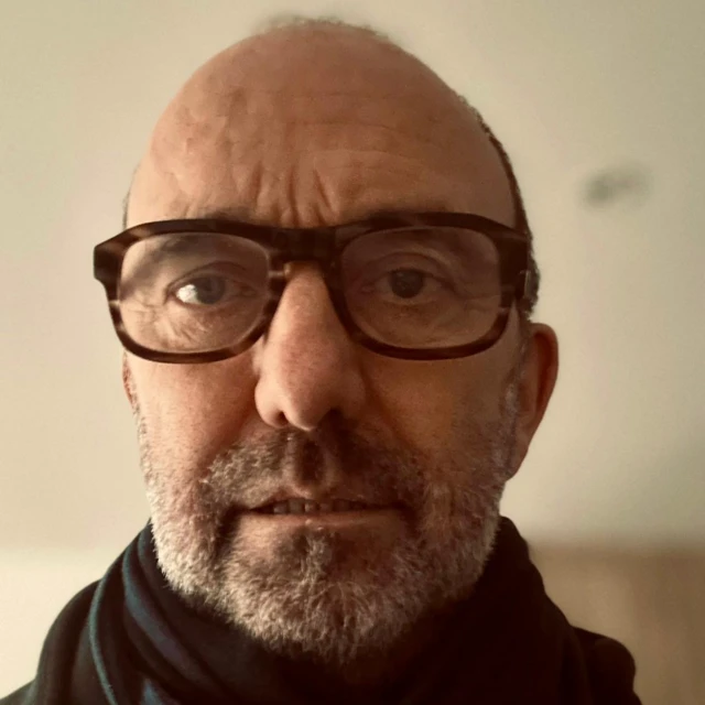 A man in glasses wearing a black turtleneck