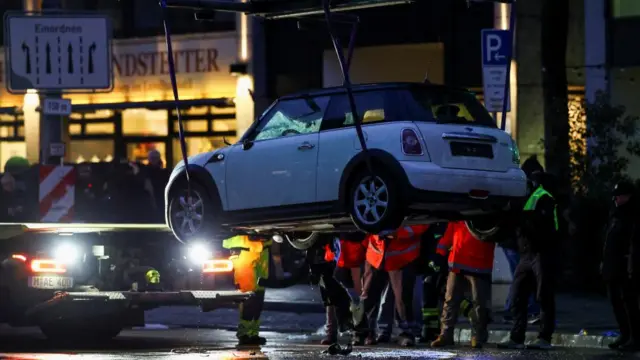 A white car is being removed from the scene of the incident