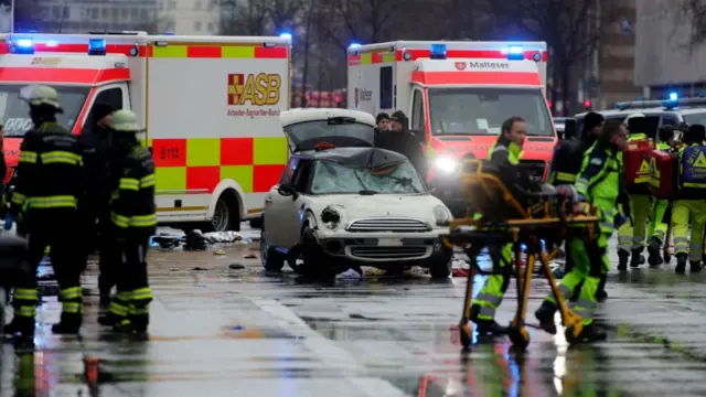 Crashed car surrounded by emergency workers