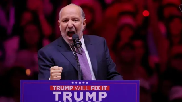 Lutnick shaking his fist at a Trump rally