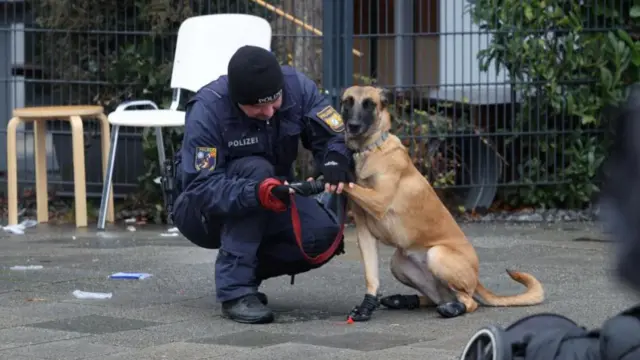 Police officer and dog at the scene of the suspected attack earlier today