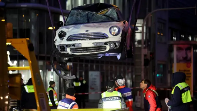 A white car is being removed from the site of the incident