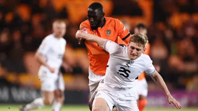 Notts County's Alassana Jatta takes on Nathan Smith of Port Vale