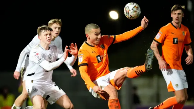 Rod McDonald kicks the ball away