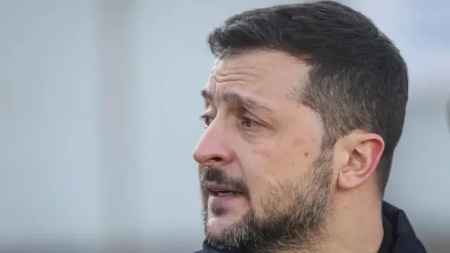 A side profile of Zelensky with a blurred background.