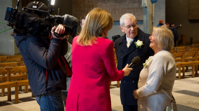 BBC staff and guests at the cathedral with a cameraman