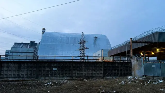 A domed structure over the power plant with a darkened mark where something has struck it