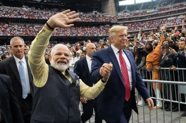 Modi and Trump hold hands and wave to a huge crowd in Houston