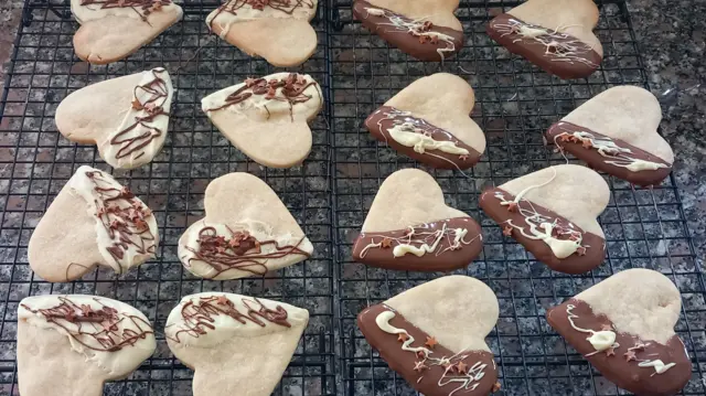 A series of heart-shaped biscuits decorated with chocolate