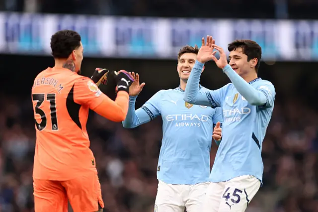 Ederson, John Stones and Abdukodir Khusanov of Manchester City celebrate