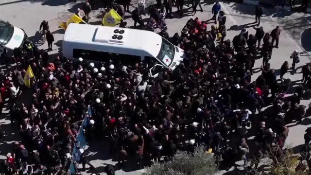 Crowds gather around the bus of the newly released Palestinian prisoners