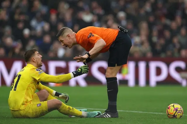 Alex Palmer (L) speaks with referee Robert Jones