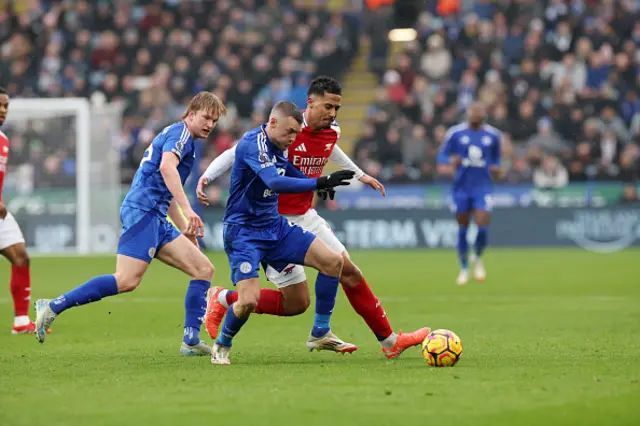 Jamie Vardy of Leicester City in action with William Saliba