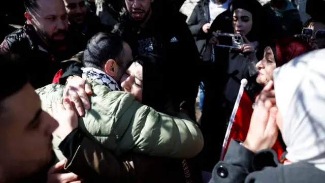 A freed Palestinian prisoner is greeted after being released from an Israeli jail as part of a hostages-prisoners swap and a ceasefire deal in Gaza between Hamas and Israel, in Ramalla