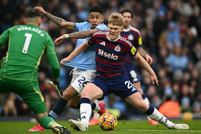 Lewis Hall (R) fights for the ball with Manchester City's #Savinho