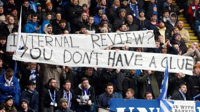 Leicester City fans with a banner in protest to Leicester City director of football Jon Rudkin