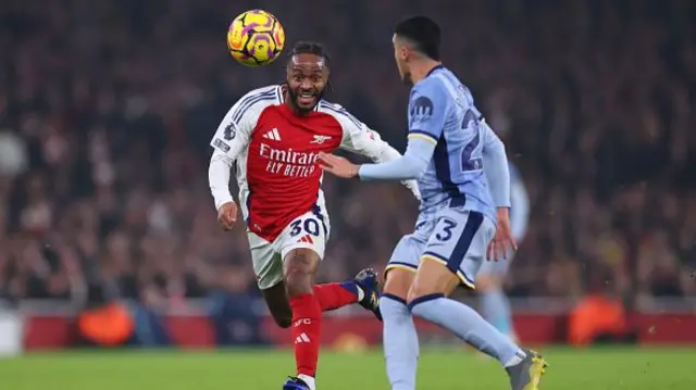 Raheem Sterling of Arsenal in action with Pedro Porro