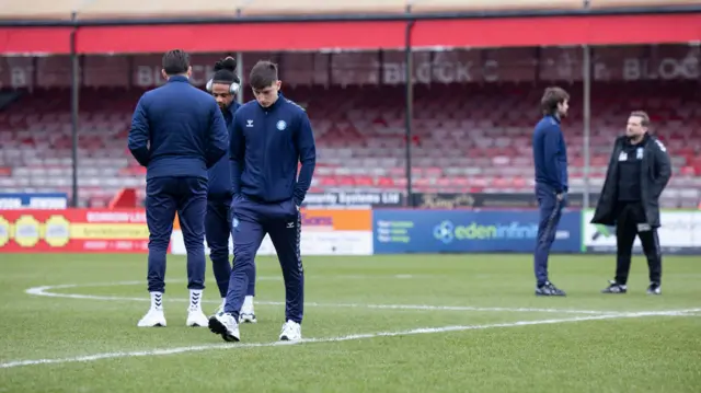 Wycombe players walk on the pitch at Crawley