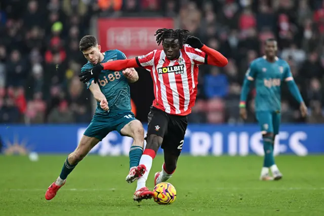 Lesley Ugochukwu of Southampton is challenged by Ryan Christie