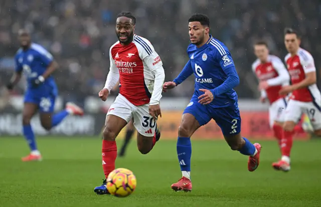 James Justin of Leicester City battles for possession with Raheem Sterling