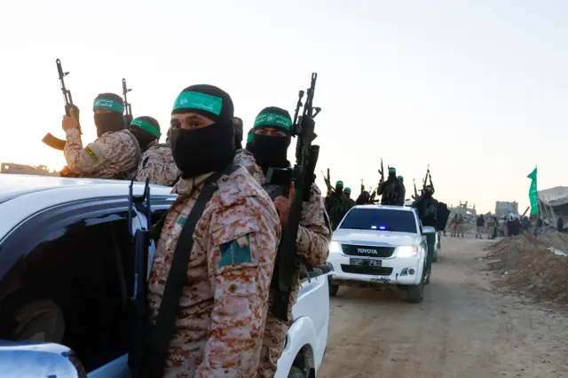 Armed Hamas militants arrive in vehicles before the release of hostages held in Gaza since the deadly October 7, 2023 attack, as part of a ceasefire and a hostages-prisoners swap deal between Hamas and Israel in Khan Younis