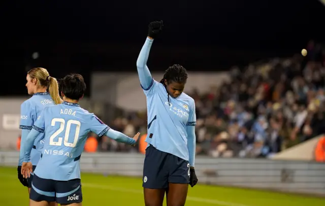 Shaw celebrates her goal with a black power salute