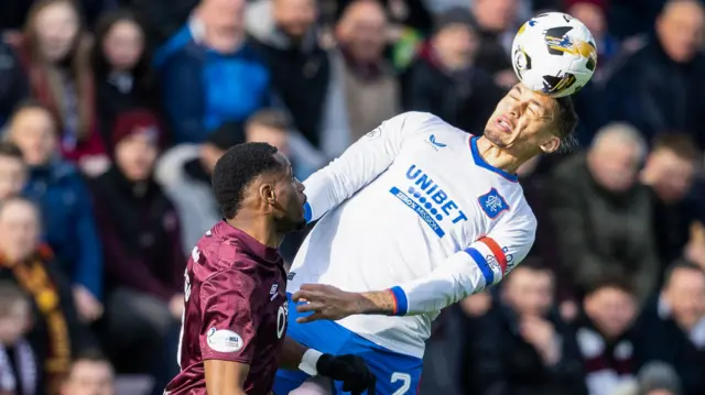 James Tavernier heads the ball for Rangers