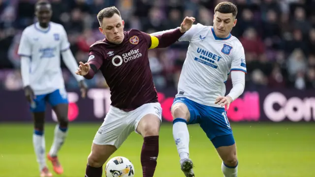 Hearts' Lawrence Shankland holds off Rangers' Tom Lawrence