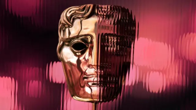 Gold BAFTA trophy with a blurred out pink background.