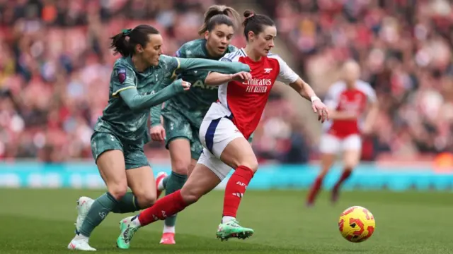 Emily Fox of Arsenal is challenged by Hayley Raso of Tottenham