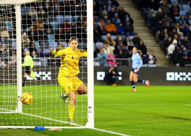 Manchester City's Gracie Prior scores their fourth goal passed Liverpool's Teagan Micah.