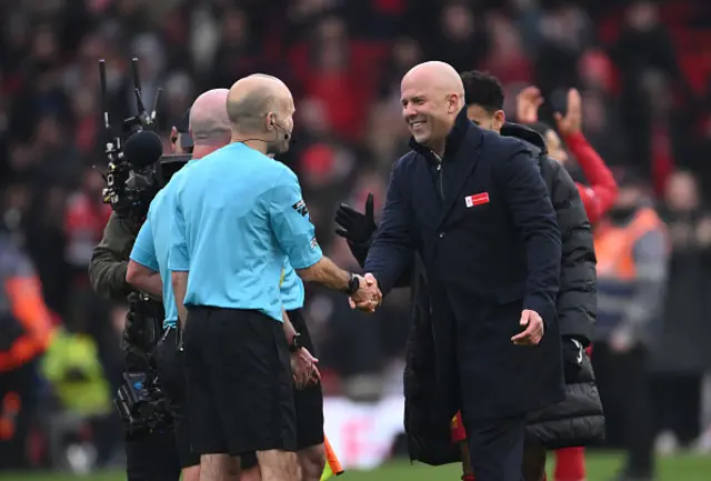 Arne Slot, Manger of Liverpool, shakes hands with the Match Officials