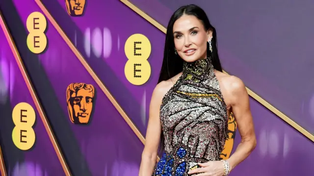 Demi Moore wearing a floor-length jeweled dress on the red carpet