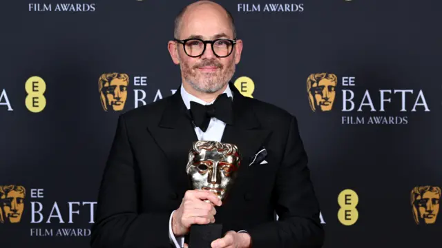 Edward Berger poses with the Outstanding British Film Award for 'Conclave' in the winners during the 2025 EE BAFTA Film Awards at The Royal Festival Hall on February 16, 2025 in London, England