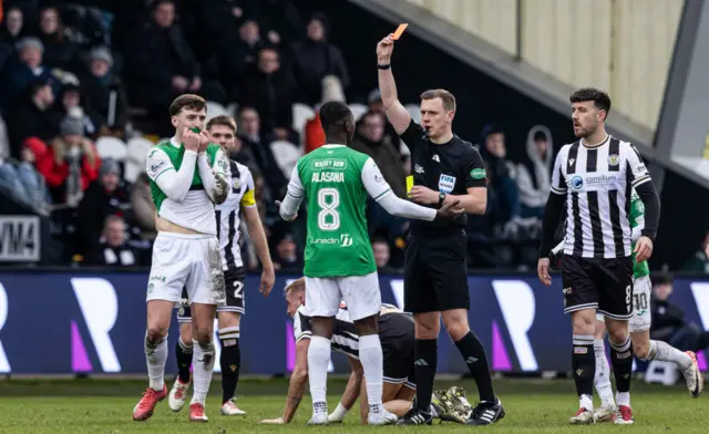 Alasana Manneh is shown a red card following two yellows on his debut