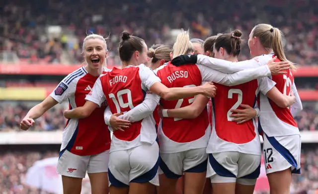 Leah Williamson of Arsenal celebrates her team's first goal with teammates