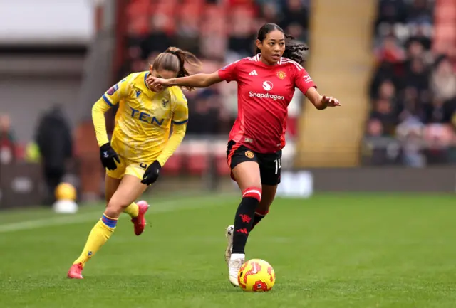 Jayde Riviere of Manchester United is put under pressure by Mille Gejl of Crystal Palace