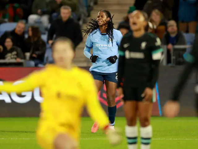 Liverpool players react as Shaw celebrates in the background