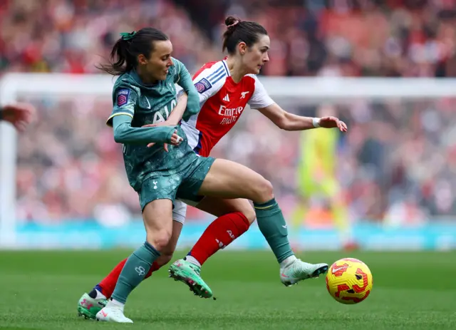 Arsenal's Emily Fox in action with Tottenham Hotspur's Hayley Raso