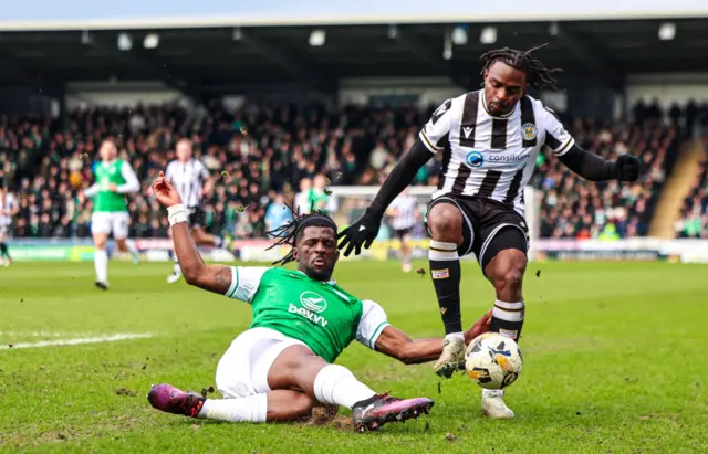 Hibernian's Rocky Bushiri tackles St Mirren's Toyosi Olusanya